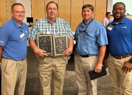 PhytoGen team members congratulate Doug Dickens -  Dickens Farms Inc - on Best Cotton award